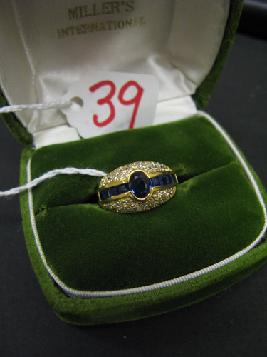 Appraisal: SAPPHIRE DIAMOND AND FOURTEEN KARAT GOLD RING centering an oval-cut