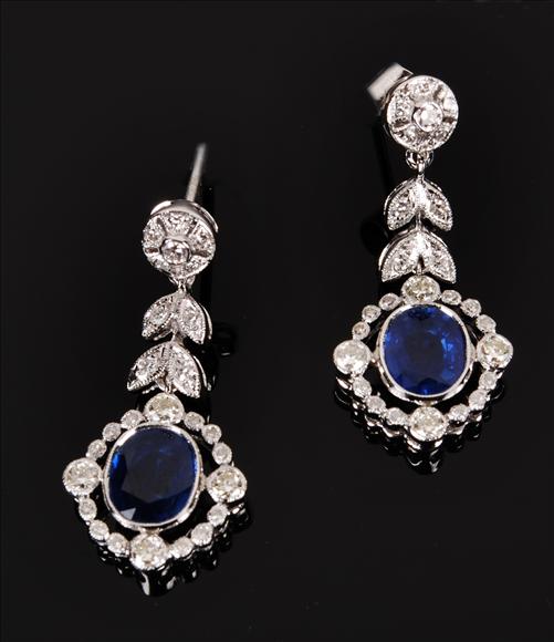 Appraisal: A pair of sapphire and diamond drop earrings the oval