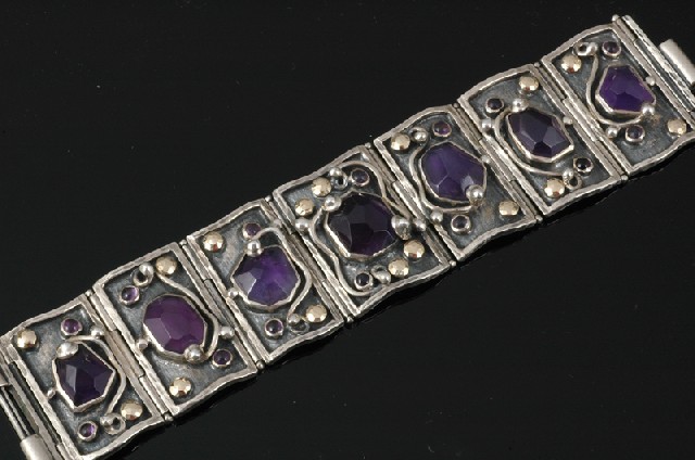 Appraisal: A STERLING SILVER GOLD AND AMETHYST BRACELET Comprising seven hinged