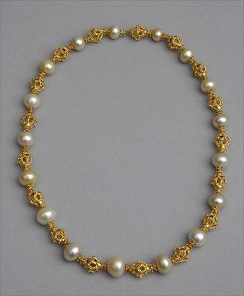 Appraisal: PEARL NECKLACE Strand of golden hued baroque pearls alternating with