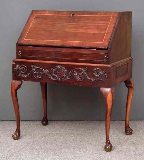 Appraisal: An th Century mahogany bureau on later stand the green