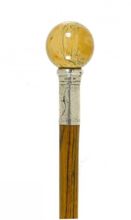 Appraisal: A HICKORY CANE with silver ferrule and ivory pommel brass