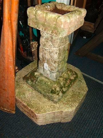 Appraisal: A reconstituted stone naturalistically moulded bird bath on octagonal plinth