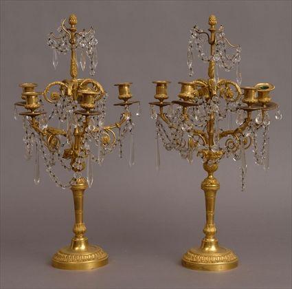 Appraisal: PAIR OF LOUIS XVI-STYLE CUT-GLASS GILT-BRONZE FIVE-LIGHT CANDELABRA Each tapered