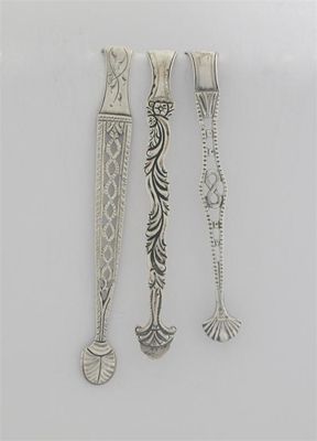 Appraisal: Three pairs of George III 'cast arm' sugar tongs various