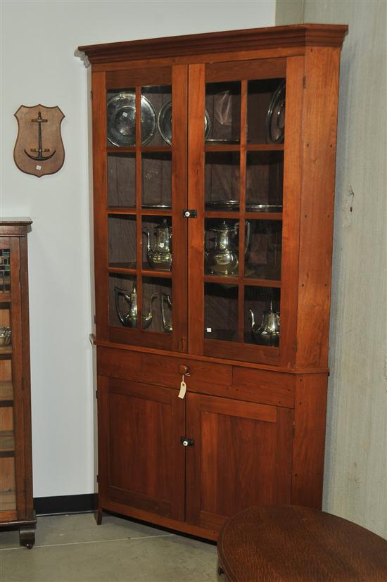 Appraisal: TWO PIECE CORNER CUPBOARD Walnut and nail constructed with a