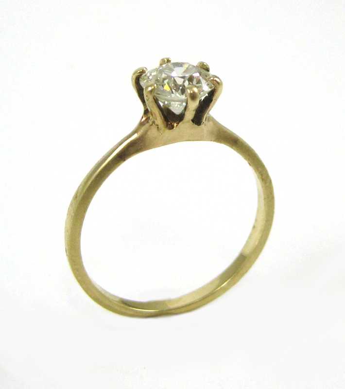 Appraisal: DIAMOND AND FOURTEEN KARAT GOLD SOLITAIRE RING with six yellow