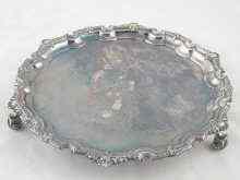 Appraisal: A silver salver with applied shell and bead rim on