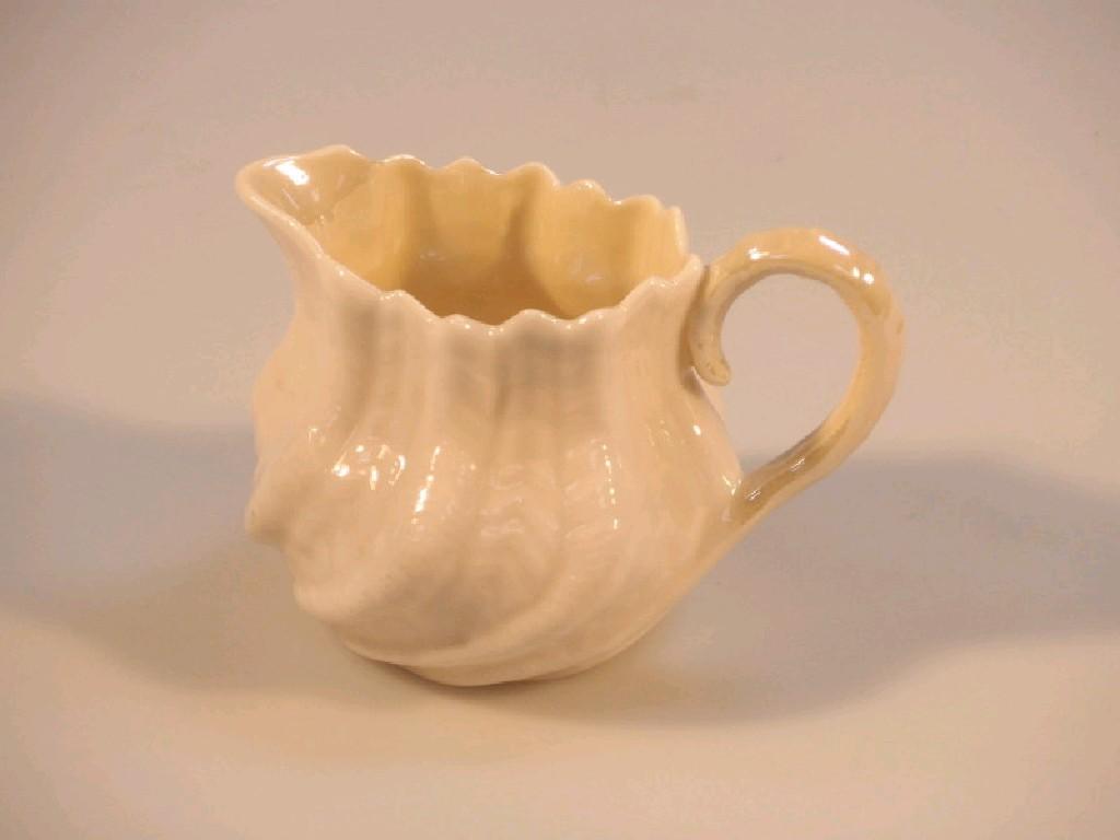 Appraisal: A Belleek porcelain cream jug with shell moulded body green