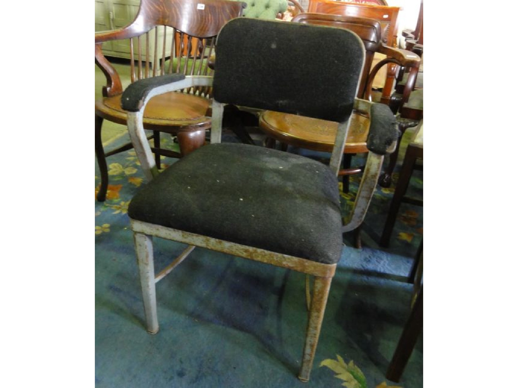 Appraisal: An industrial open armchair with upholstered seat padded back and