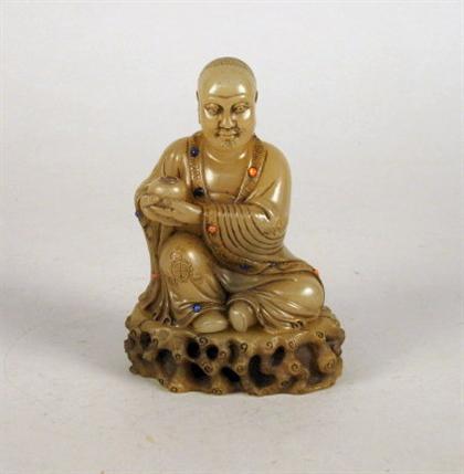 Appraisal: Chinese soapstone lohan Well-carved robed and sitting figure adorned with