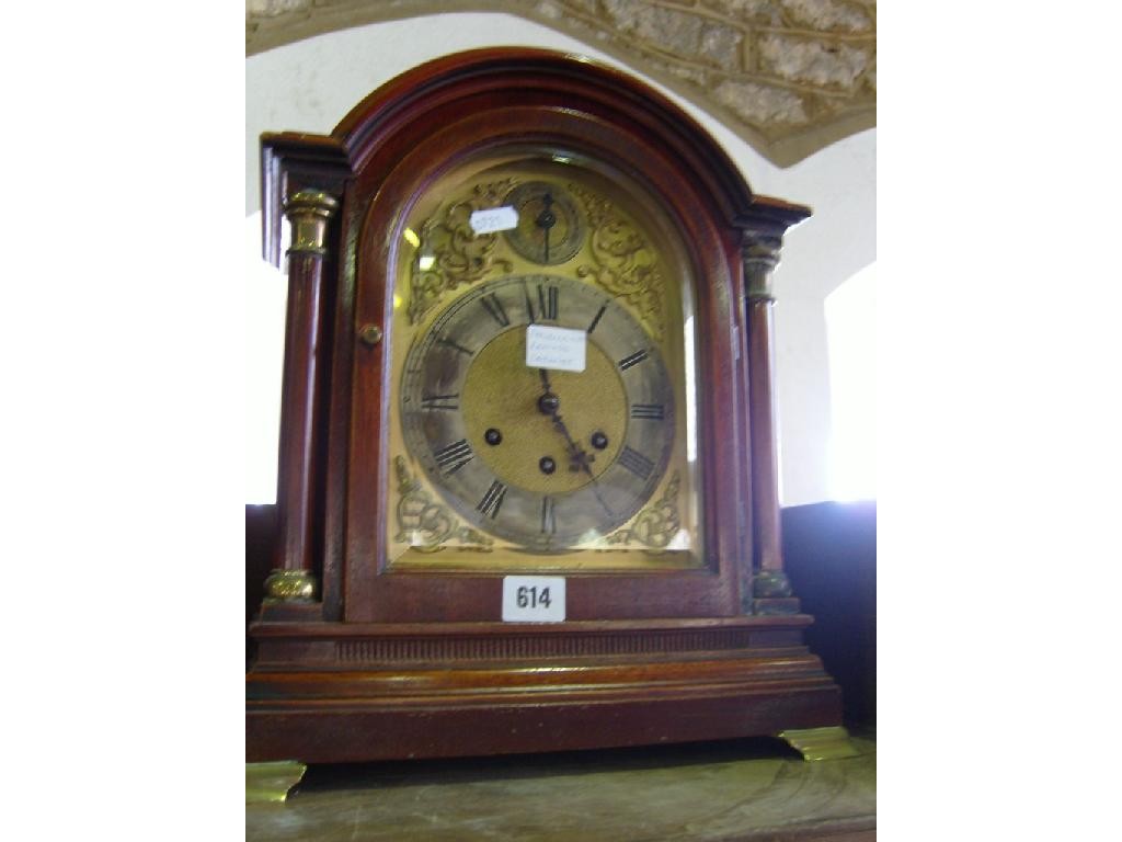 Appraisal: An Edwardian mahogany bracket clock with turned column supports enclosing