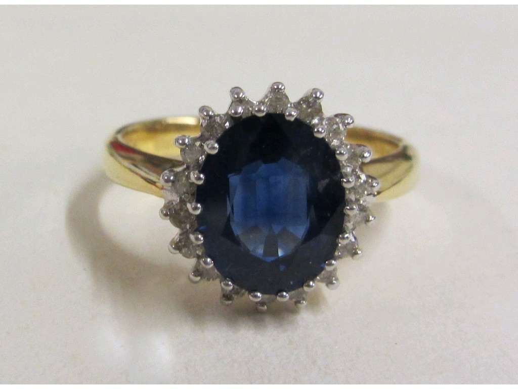 Appraisal: Eighteen carat gold sapphire and diamond cluster ring with oval