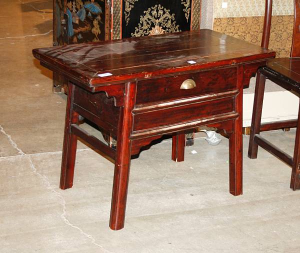 Appraisal: A Chinese lacquered pine one-drawer coffer table With metal handle