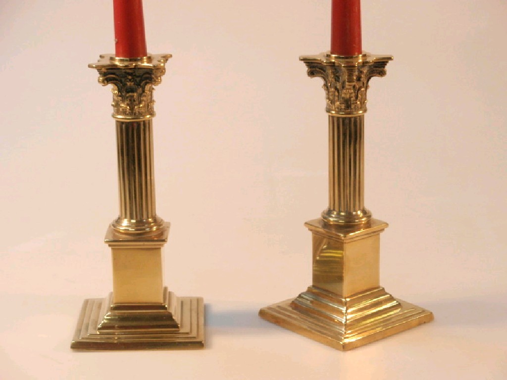 Appraisal: A pair of brass Corinthian columnar candlesticks cm