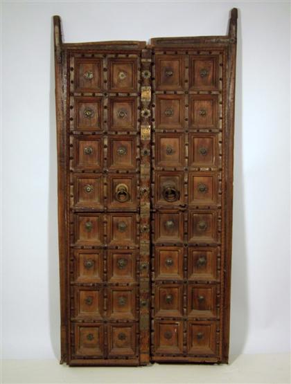 Appraisal: Pair of Spanish iron-mounted walnut doorsA gadrooned frame around two