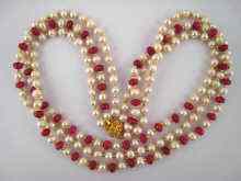 Appraisal: A faceted ruby bead and freshwater pearl three row necklace