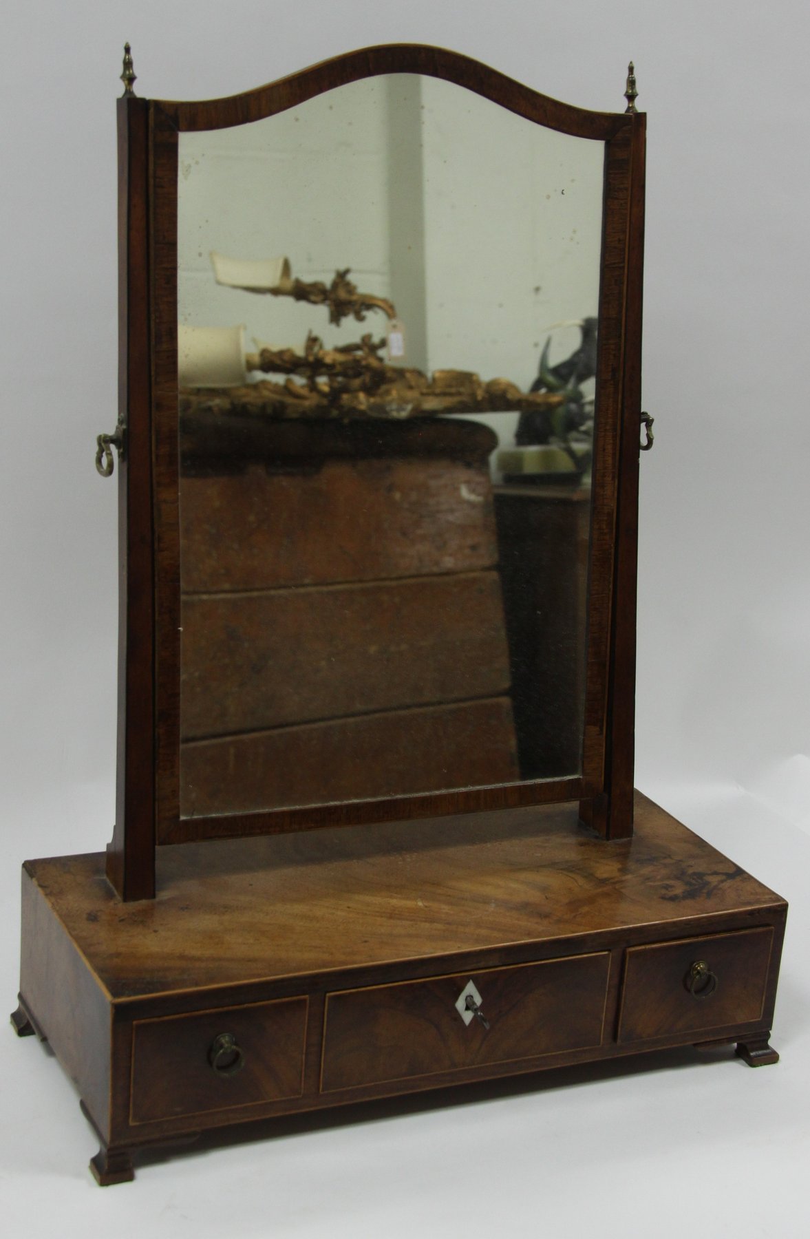 Appraisal: A mahogany swing-frame toilet mirror the box base fitted three