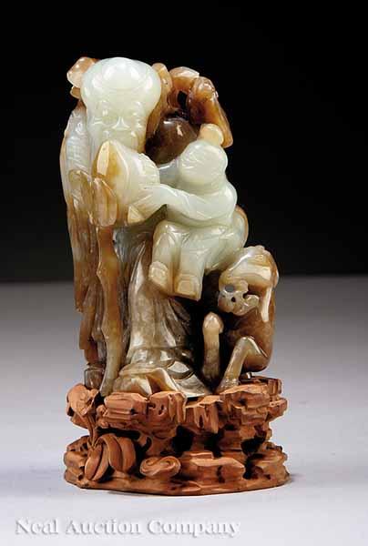 Appraisal: A Chinese Pale Green and Russet Jade Carved Figural Group