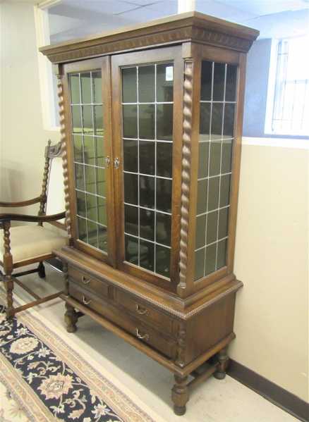 Appraisal: AN OAK AND LEADED GLASS CHINA CABINET ON STAND Continental