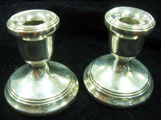 Appraisal: A pair of miniature silver candlesticks cm wide Birmingham