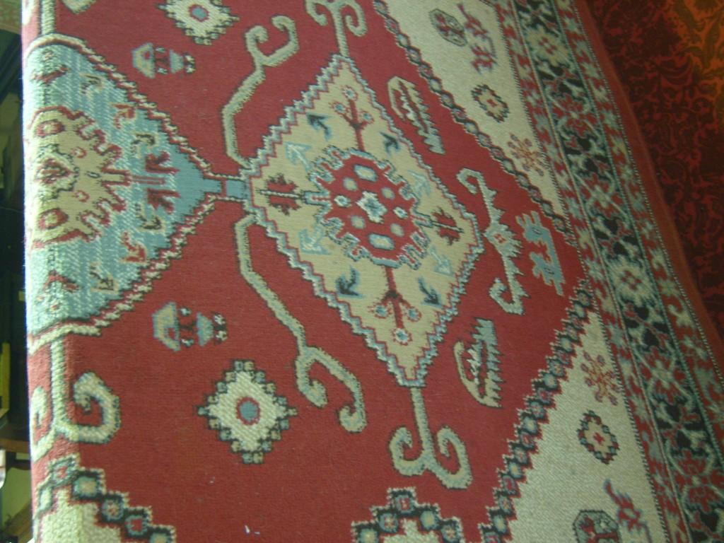 Appraisal: A wool carpet in a Persian style with red ground