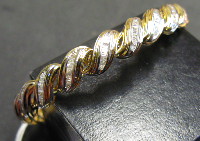 Appraisal: DIAMOND AND FOURTEEN KARAT YELLOW AND WHITE GOLD BRACELET with