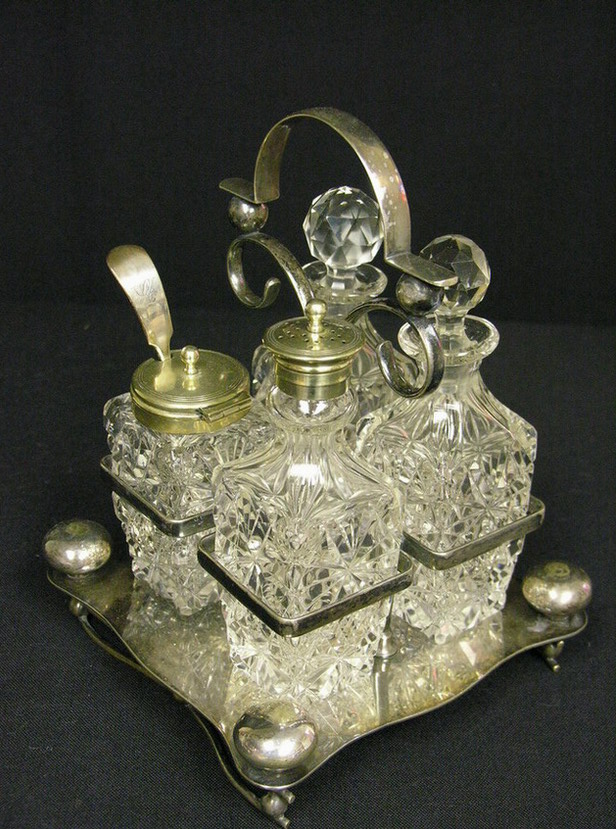 Appraisal: CUT GLASS CONDIMENT SET carrier stand is marked E P