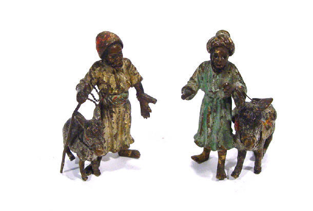 Appraisal: Two cold painted bronze groups of Arabs beside donkeys each