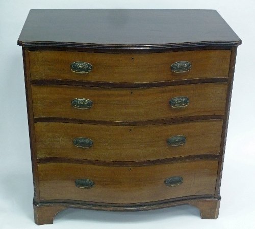 Appraisal: A mahogany serpentine front chest of four drawers the top