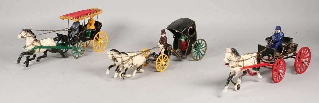 Appraisal: cast iron carriage toys A police chief and passenger carriages