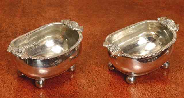 Appraisal: A PAIR OF OVAL GEORGE III SILVER SALTS with gadrooned