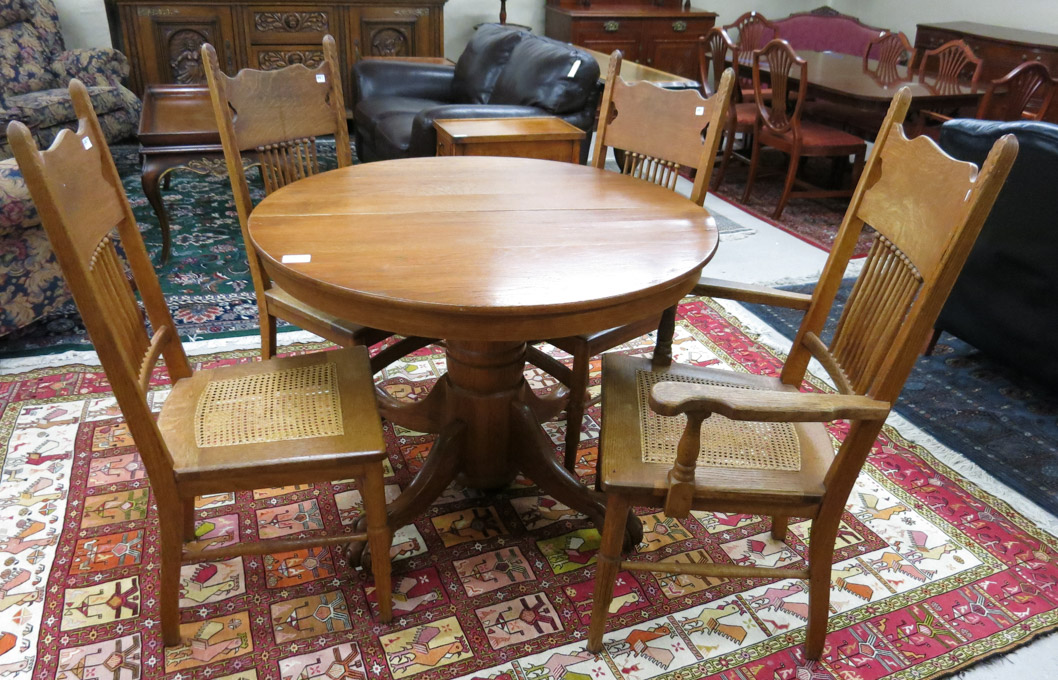 Appraisal: ROUND OAK DINING TABLE FOUR CHAIRS AND TWO LEAVES American