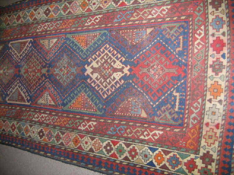 Appraisal: SHIRVAN TRIBAL THROW RUG The geometric field shows a central