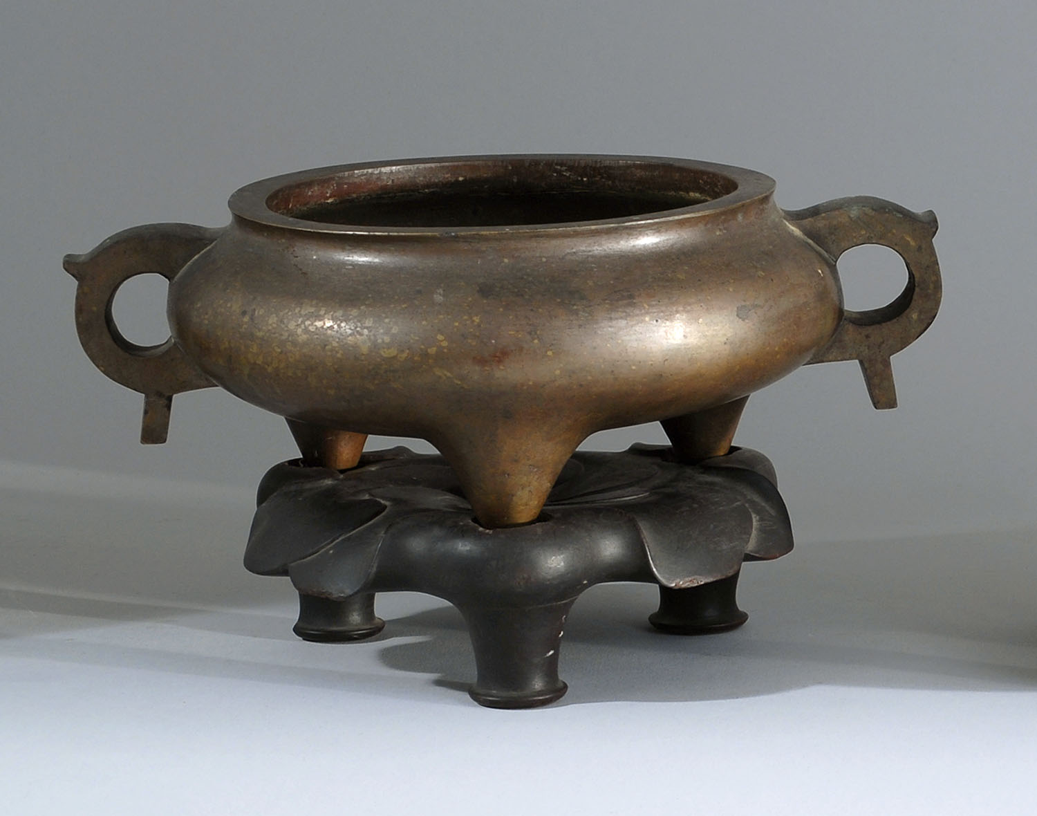 Appraisal: BRONZE THREE-FOOTED DING Ming DynastyWith heavy loop handles Extensive Ming