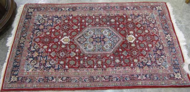 Appraisal: A handmade Oriental rug Kazak red field ' x '