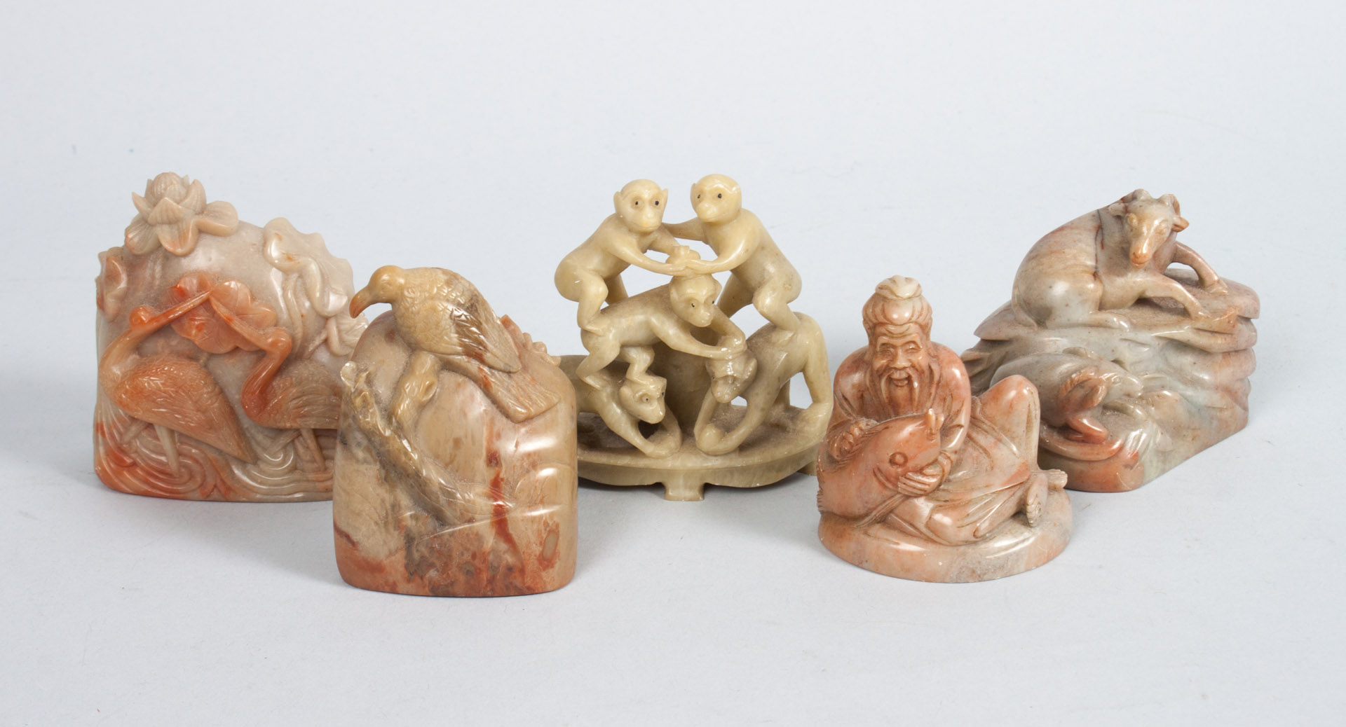 Appraisal: Five Chinese carved hardstone and soapstone groups hardstone groups include