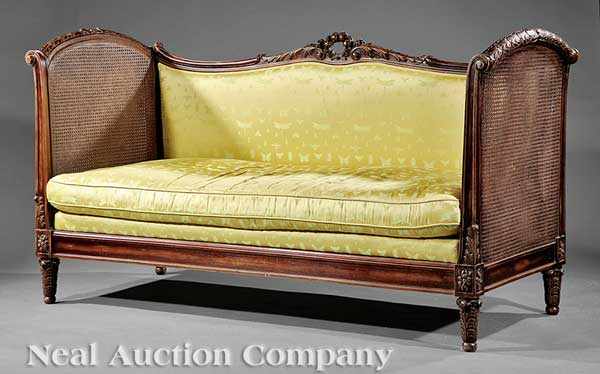 Appraisal: A Louis XVI-Style Carved Walnut and Caned Canap upholstered back