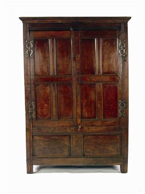 Appraisal: A panelled oak cupboard with a moulded cornice and a