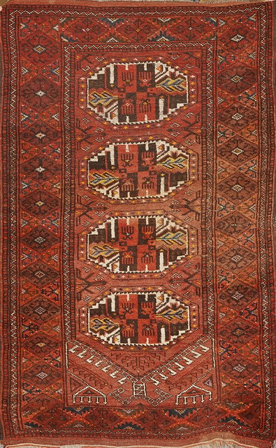 Appraisal: AN AFGHAN WINE GROUND RUG with four octagonal medallions within