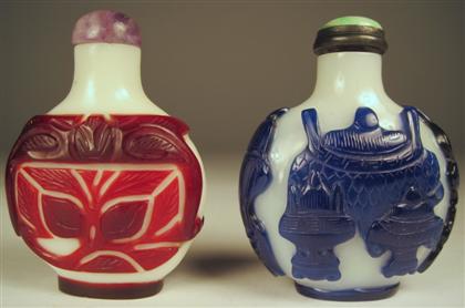 Appraisal: Two Chinese glass overlay snuff bottlesComprising a rounded milk glass