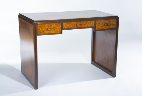 Appraisal: EUROPEAN ART DECO Three-drawer desk with burlwood veneer panels to