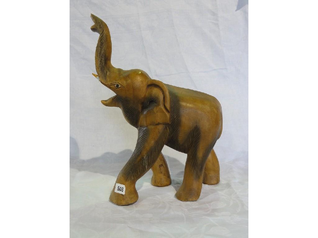 Appraisal: A carved wooden elephant with raised trunk