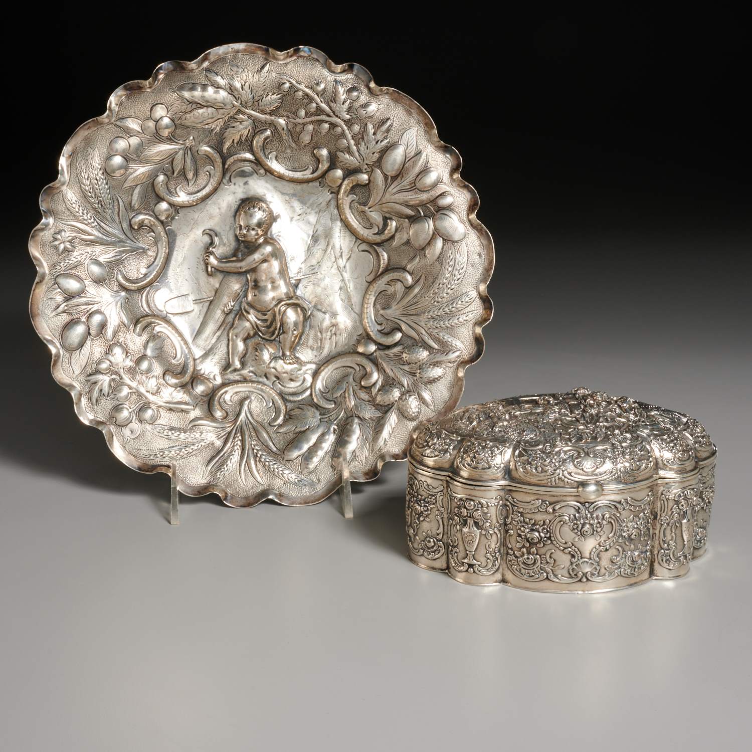 Appraisal: GERMAN REPOUSSE SILVER HINGED BOX AND PUTTO DISH th th