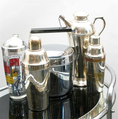 Appraisal: An Art Deco chrome and mirrored glass drinks trolley elliptical