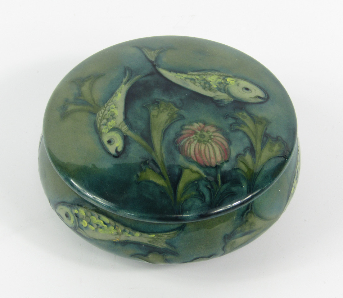 Appraisal: A Moorcroft pottery powder box and cover decorated with fish