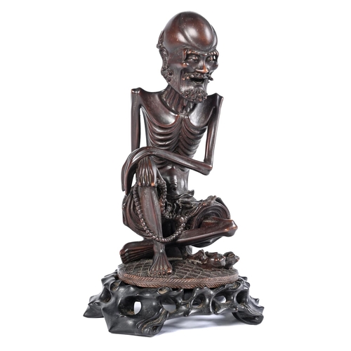 Appraisal: A Chinese rootwood one piece figure of an Sakyamuni probably