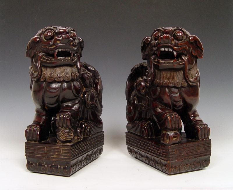 Appraisal: LARGE PAIR CARVED HARD WOOD FOO DOGS Male with a