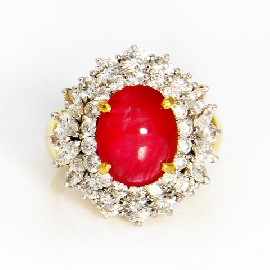 Appraisal: An ct gold treated cabochon ruby and diamond cluster ring