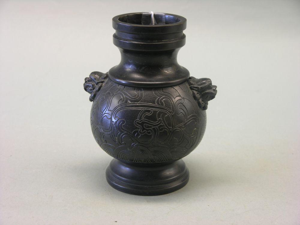 Appraisal: A Japanese bronze vase bulbous shape with incised detail grotesque